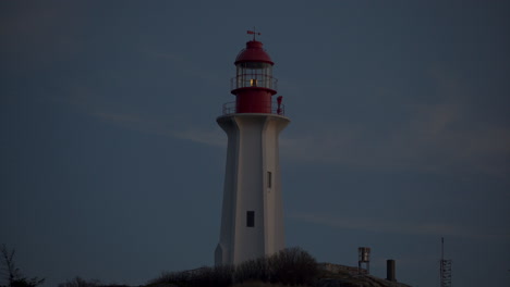 a close-up nighttime view of the point atkinson light house framed left of center
