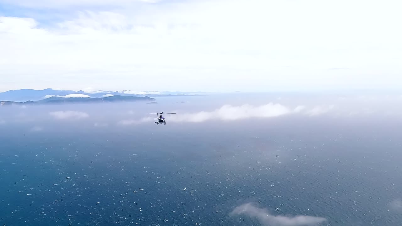 Helicopter flying over the Cook Strait towards the South Island of New Zealand