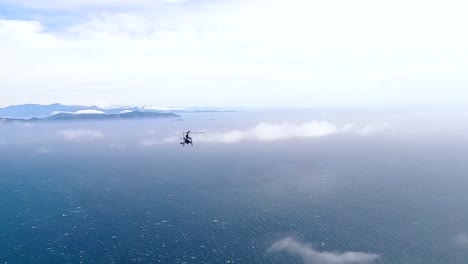 helicopter flying over the cook strait towards the south island of new zealand