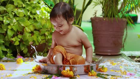 cute toddler baby boy bathing in decorated bathtub at outdoor from unique perspective