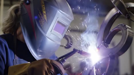 woman welding metal sculpture