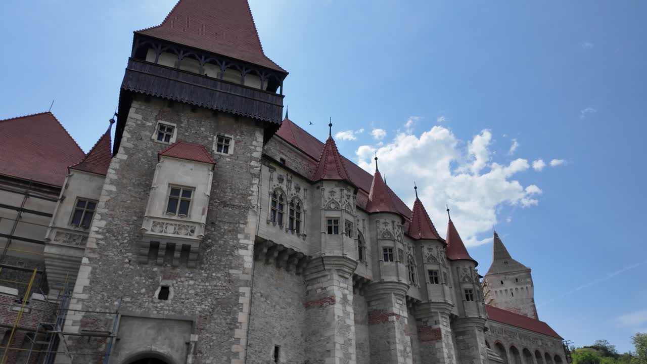 Pan across Corvin Castle’s fortress exterior, capturing stonework, rooftops, and classic medieval architecture