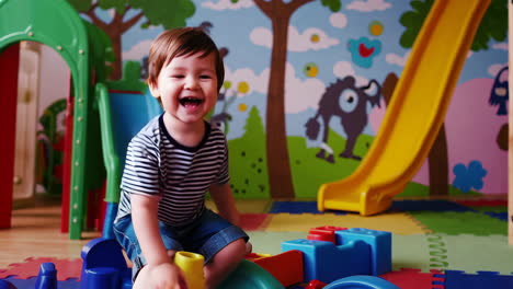 joyful toddler playing on an indoor playground