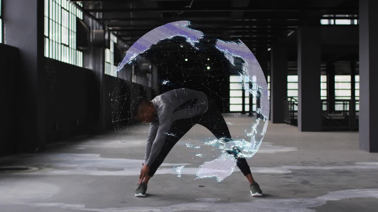 Man warming up warehouse, leaning reaching ankle while motion starting globe over torso for fitness
