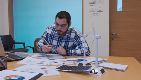 project manager organizing documents for a renewable energy presentation