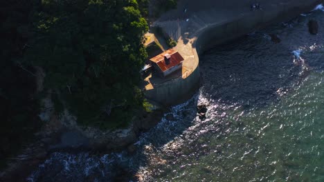 Ama-Diver-Hut-in-Osatsu-Japan,-Aerial-Tilt-Establishing-Shot-on-Sunny-Day