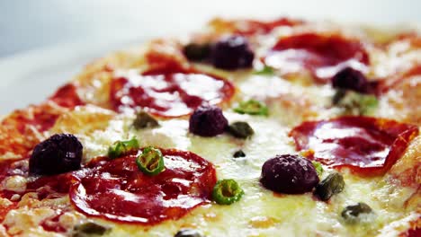 Baked-pizza-with-avocado,-cherry-tomato-and-olive-toppings