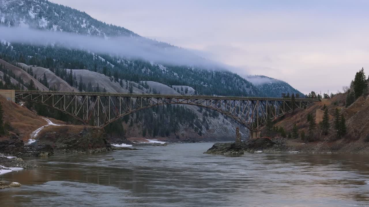 4K CGI footage of a modern bridge spanning the Fraser River in British Columbia, highlighting advanced infrastructure against scenic Canadian landscapes.
