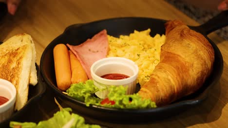 a hearty breakfast with croissant and ham