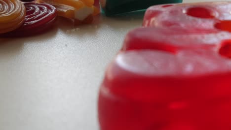 panning movement a bit diagonally of jellies on a table in studio environment at home