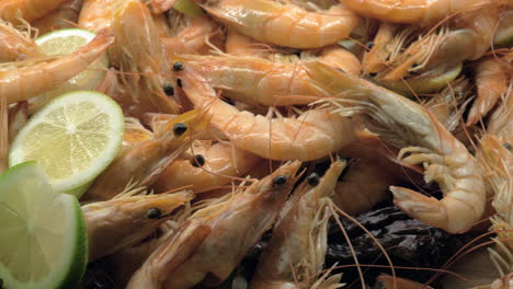 a closeup of cooked shrimpes decorated with lemon and lettuce