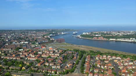 aerial footage of north shields and tynemouth featuring the river tyne, coastline, and residential areas with clear skies