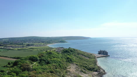 Wide-aerial-shot-looking-over-the-coast-line-of-the-Isle-of-Wight,-bright-sunny-day