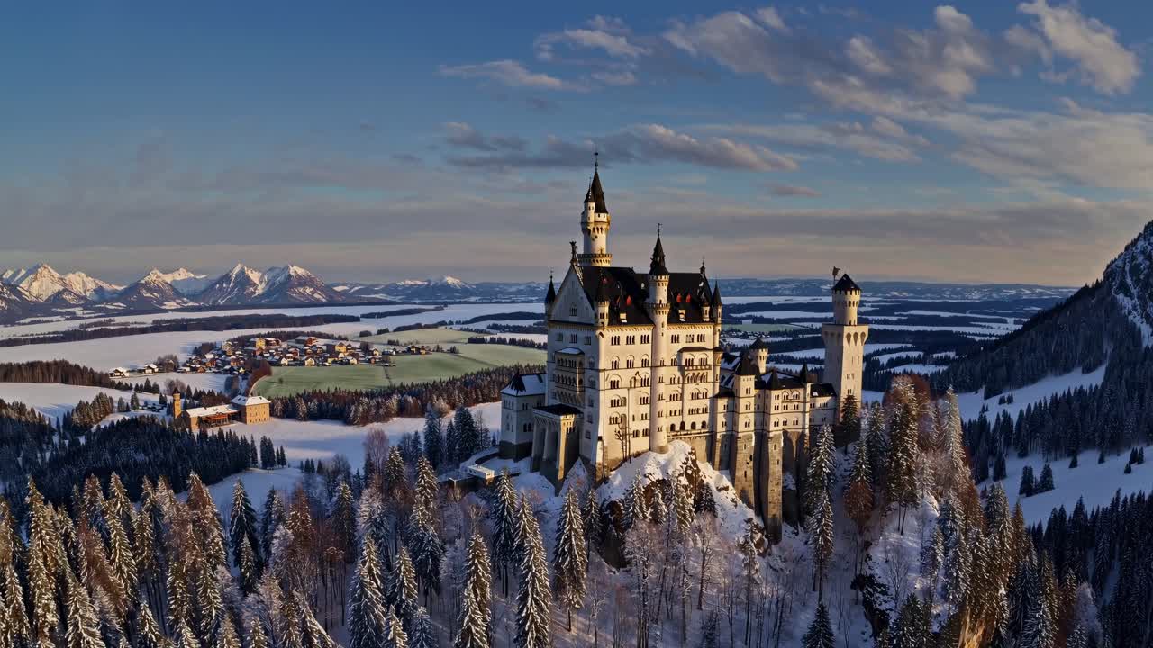 Aerial video showcasing a majestic castle amidst a snowy landscape, capturing its grandeur