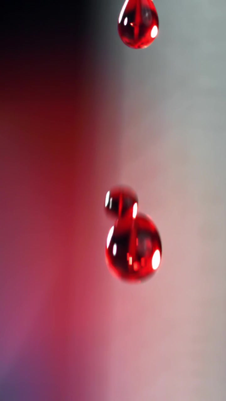Red Liquid Drops Falling in Slow Motion
