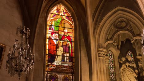 stained glass paintings on the windows of a catholic church