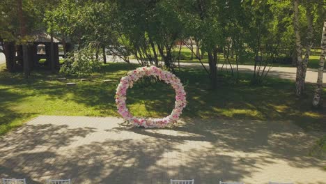 wedding venue with flowers and empty chairs in park upper