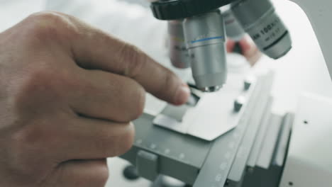 scientist working with a microscope