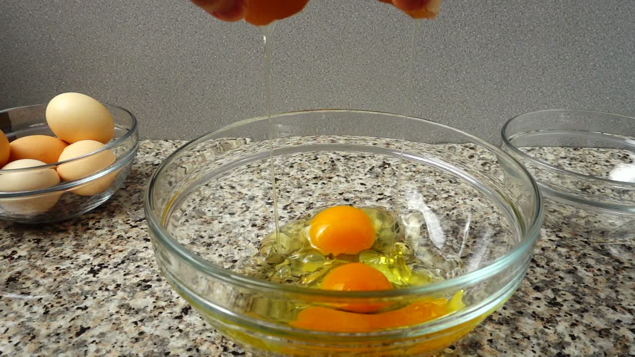 Falling of contents of egg in a bowl. Slow motion