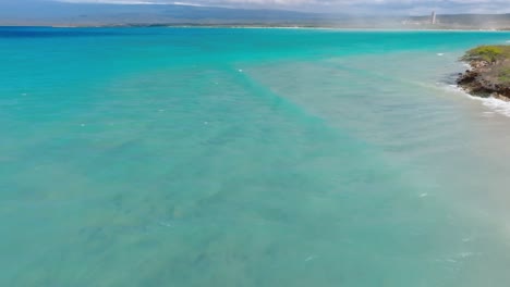 Aerial-flyover-turquoise-Caribbean-Sea-with-clear-water-in-Pedernales,-Dominican-Republic