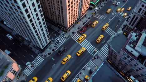 aerial view of a city street with yellow cabs and traffic