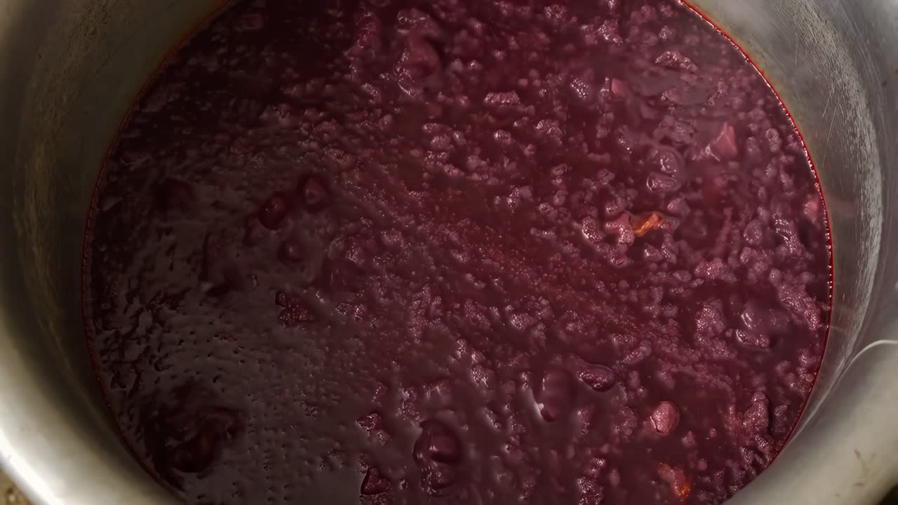 Red liquid boiling in a large pot