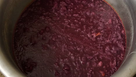 red liquid boiling in a large pot