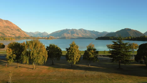 lake wanaka as seen from the resort town of wanaka on the south island of new zealand - sliding aerial