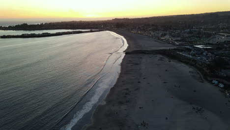 aerial view of santa cruz boardwalk and beach california over the sand at sunset shot in 4k high resolution