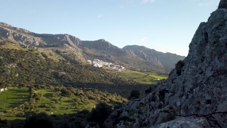 Reveal-of-Spanish-pueblo-blanco-Benaocaz-beyond-rugged-mountain-and-valley