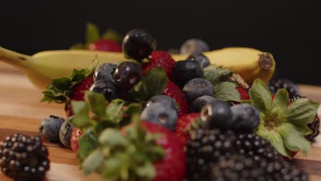 blueberries being dropped on a pile of spinning fruit