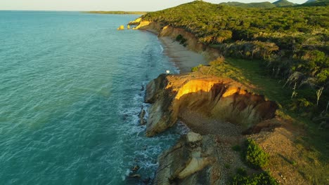 one person on cliff of popa beach in dominican republic