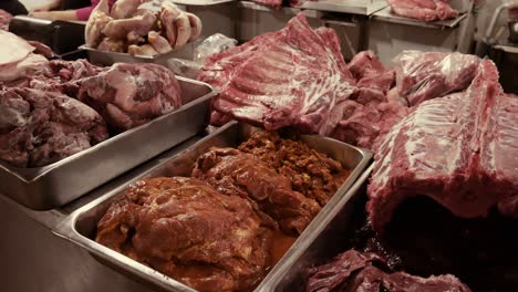 butcher shop with various beef products and butcher working