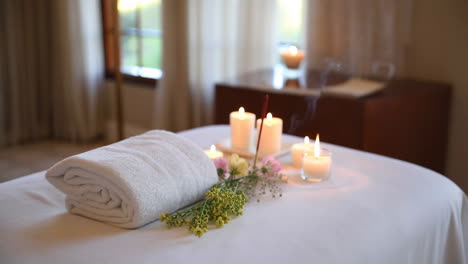serene spa setting with candles and towel