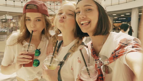 three friends taking a selfie in a shopping mall