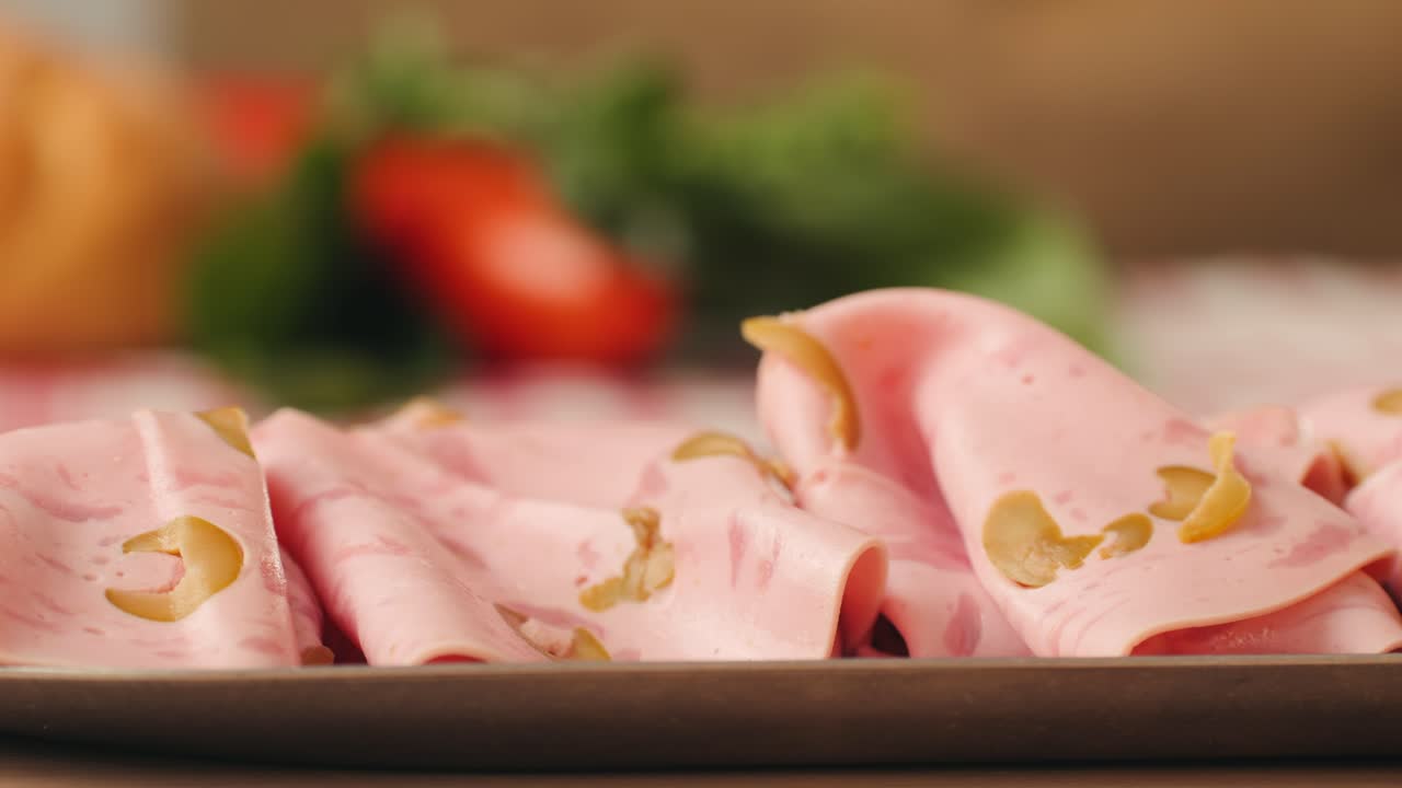 Ham italian mordatella, man Slices Of Traditional Italian antipasti mortadella sausage on a wooden cutting board, close up macro of chicken or turkey jamon, fat breakfast dish.