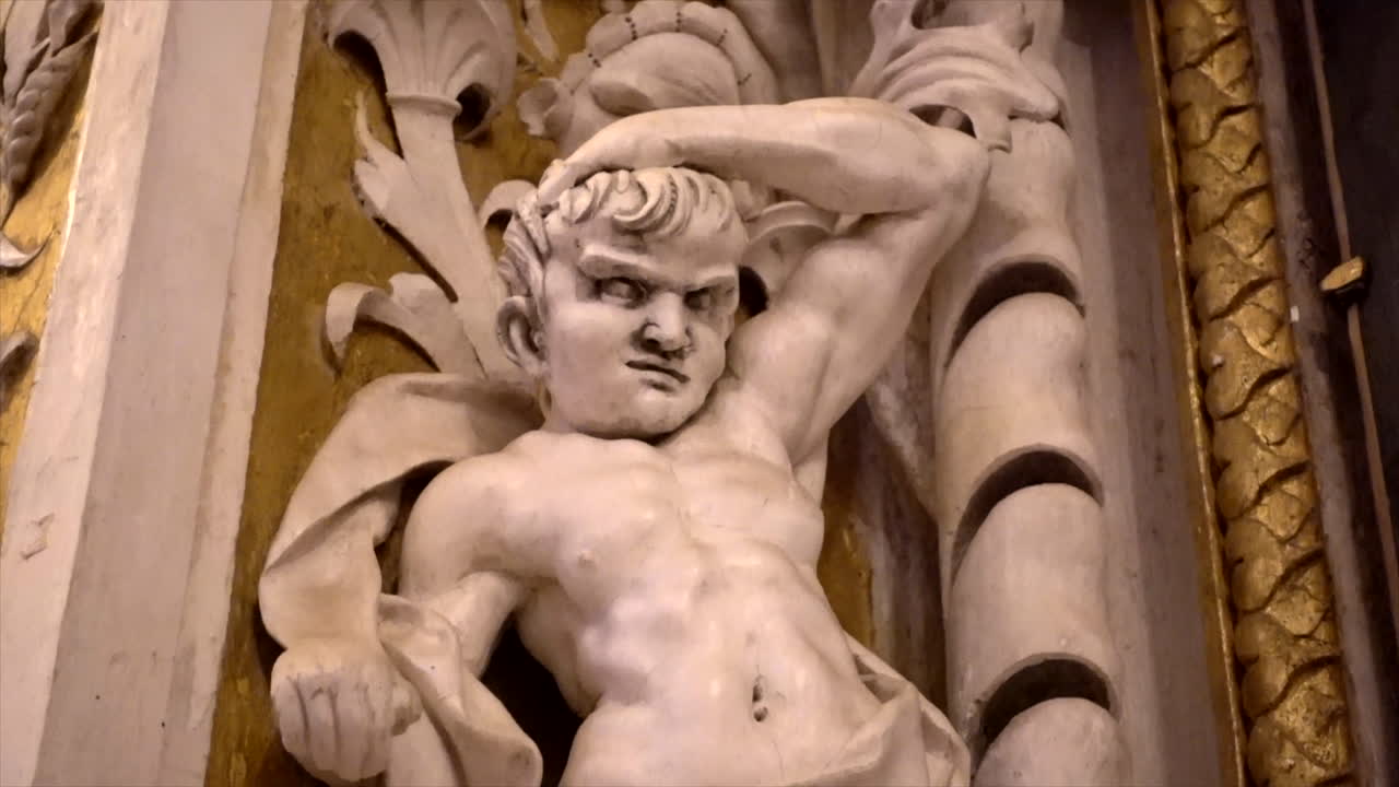 Stuccoes and statues inside the Serpotta Chapel of Castelbuono Castle, Sicily. Angels, devils, and fierce demonic faces decorate this masterpiece, showcasing Baroque artistry at its finest.