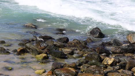 dynamic ocean waves hitting a boulder-strewn coast