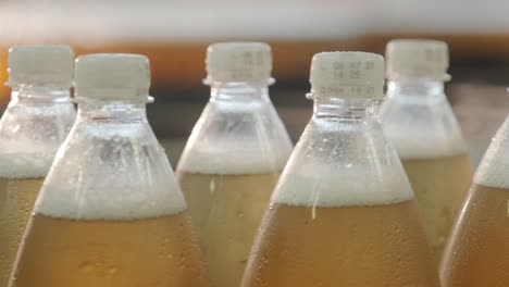 conveyor belt with bottles for juice or water at a modern beverage plant. modern production of sweet soda water