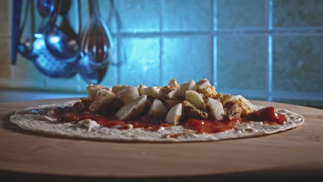 Close-Up-Of-Chicken-And-Egg-Tortilla-Being-Prepared-On-A-Wooden-Board-In-The-Kitchen