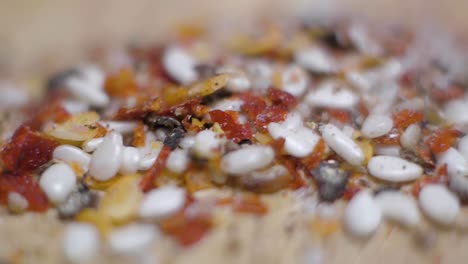 Coarsely-ground-spices-extreme-close-up-flyover-macro-seasoning-on-wooden-cutting-board