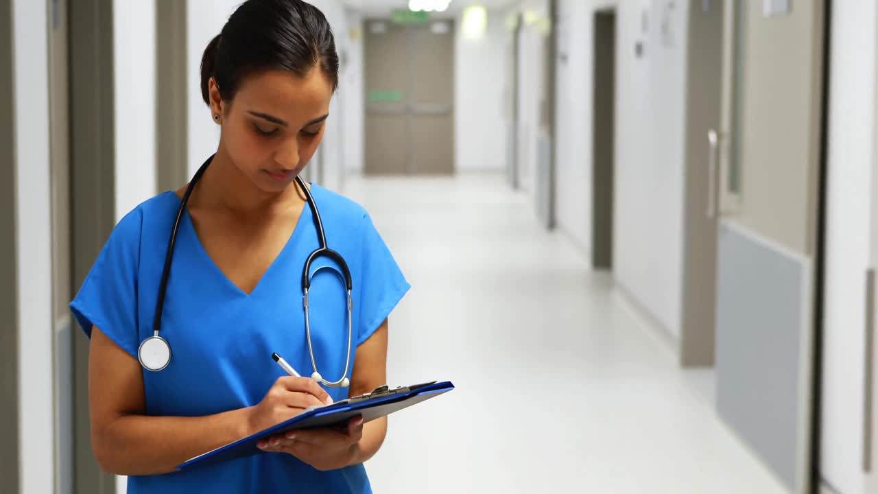 retrato de una doctora escribiendo en un clipboard