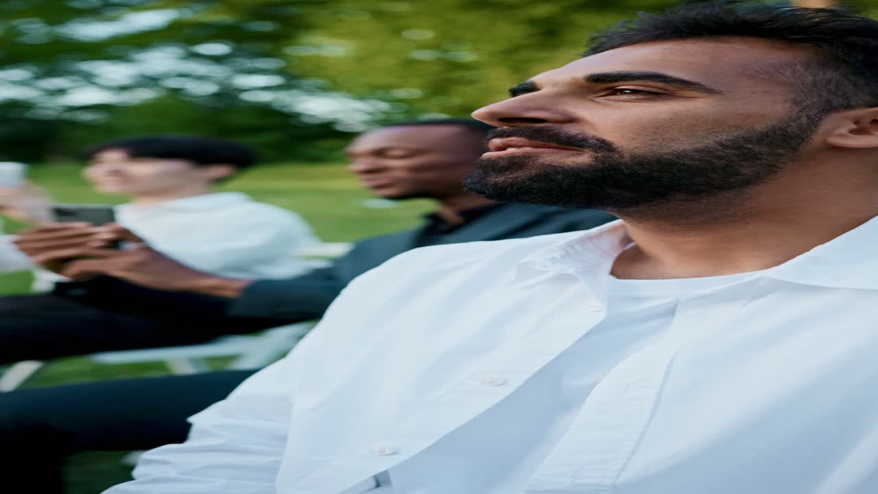 A group of men sitting on lawn chairs