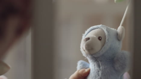 a closeup of a toy bear being played by a baby