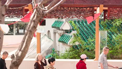 people walking past temple in hong kong