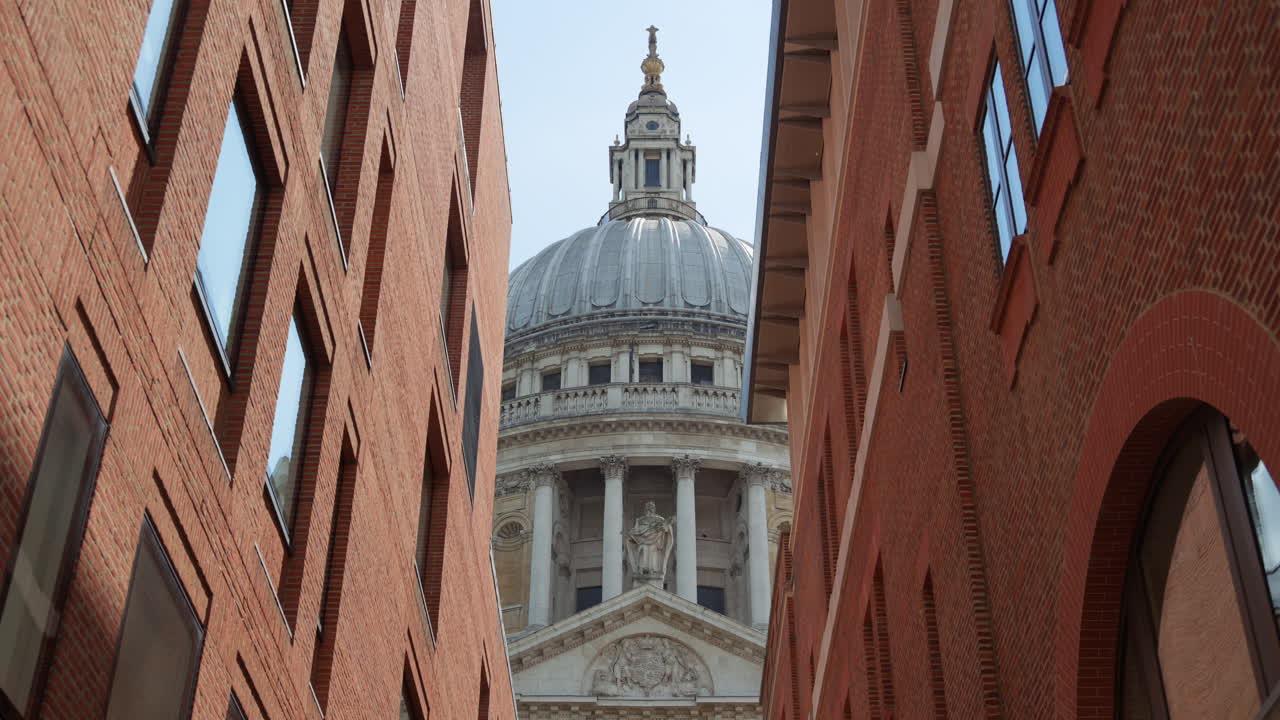 Framed view of St. Paul's Cathedral dome between two modern brick buildings in London, England