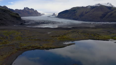 Aerial:-Heading-towards-a-massive-glacier-in-Iceland-during-overcast-day