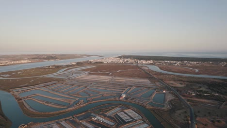 Drone-flying-backwards-over-Castro-Marim-in-Portugal-revealing-the-great-landscape-of-its-land-in-daylight