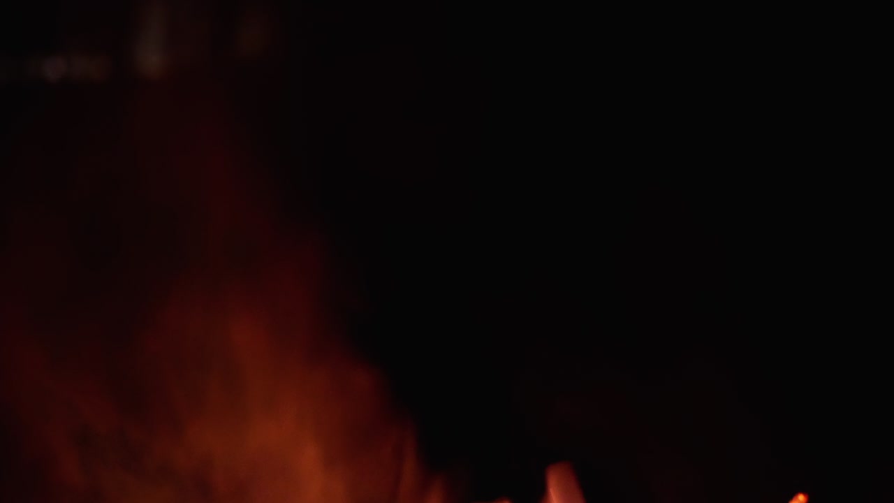 Sparks fly up on a black background and with smoke