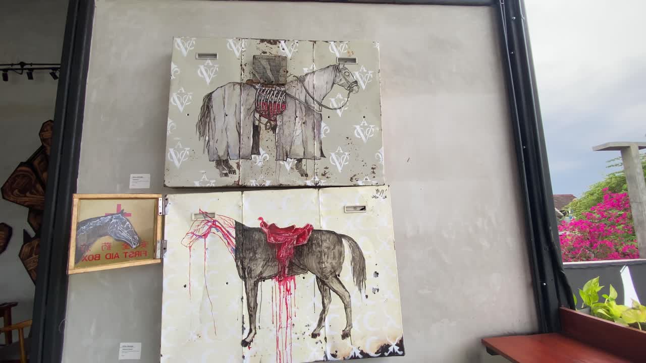 The footage shows the interior of a coffee shop that displays paintings and graffiti on every wall.